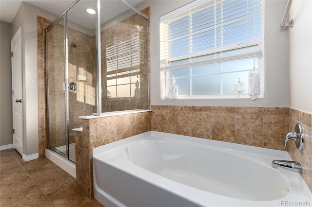 full bath with a stall shower, tile patterned flooring, and a garden tub