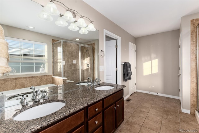 full bathroom featuring visible vents, a sink, a shower stall, and tile patterned floors