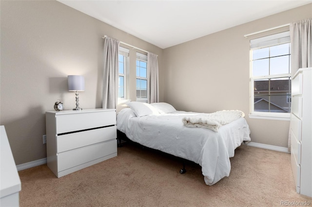 carpeted bedroom with baseboards