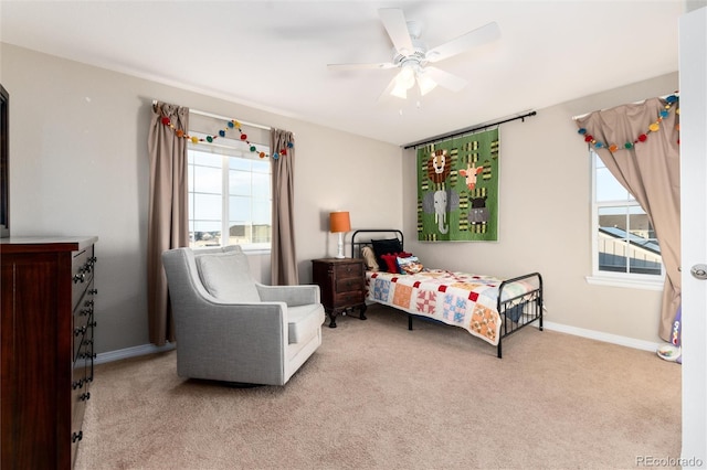 bedroom with light carpet, ceiling fan, and baseboards