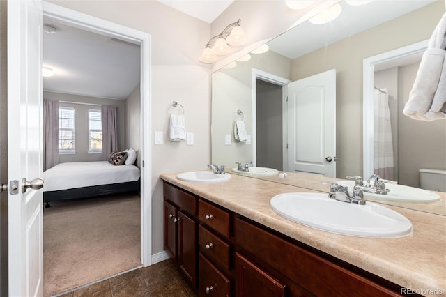 bathroom featuring tile patterned flooring, a sink, and double vanity