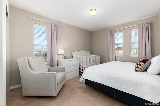 bedroom with light carpet and multiple windows