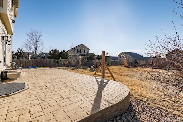 view of patio / terrace featuring a playground and a fenced backyard