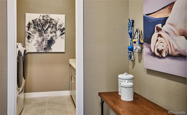 16500 Black Rose Cir, Parker, CO 80134 - interior space with independent washer and dryer, light tile patterned flooring, a textured wall, and baseboards