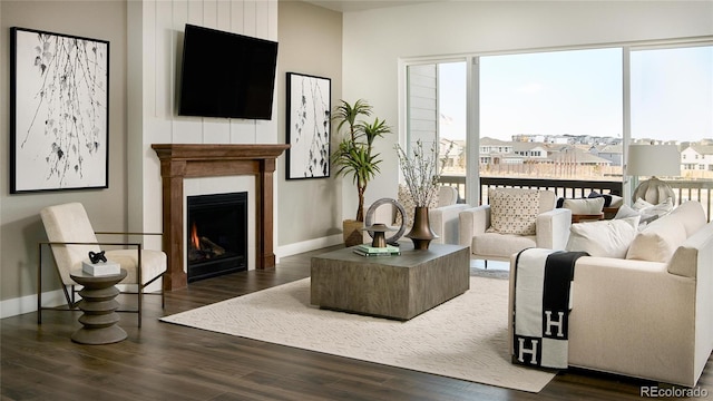 16500 Black Rose Cir, Parker, CO 80134 - living area featuring baseboards, a lit fireplace, wood finished floors, and a healthy amount of sunlight