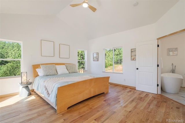 bedroom with multiple windows, light wood-style floors, a ceiling fan, high vaulted ceiling, and baseboards
