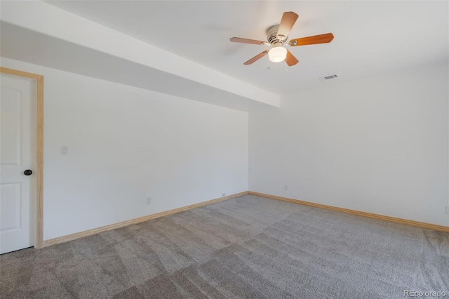 spare room with carpet flooring, a ceiling fan, and baseboards