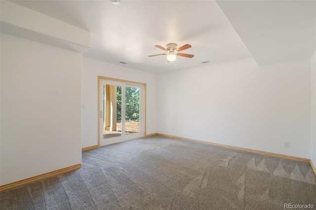 carpeted empty room featuring ceiling fan and baseboards
