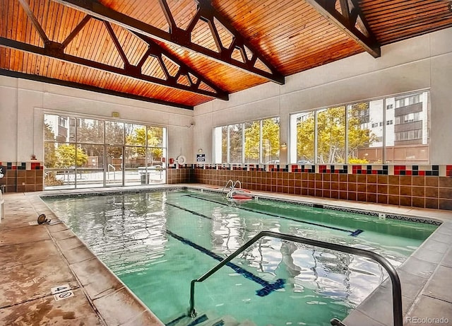 view of swimming pool with a ceiling fan and fence