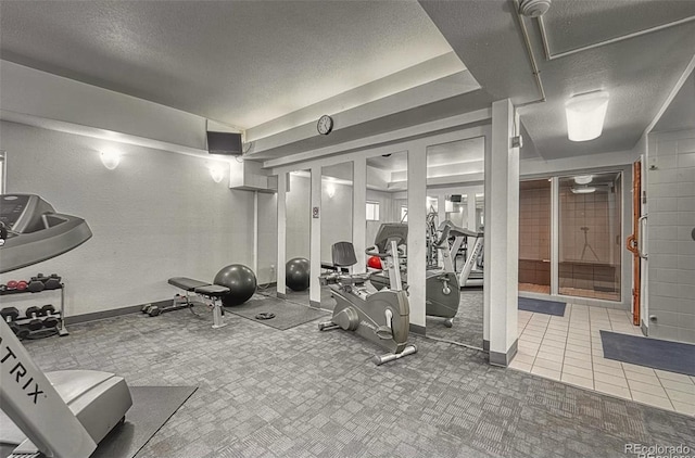 gym featuring carpet floors and a textured ceiling