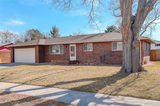 ranch-style house with brick siding, concrete driveway, an attached garage, a front yard, and fence