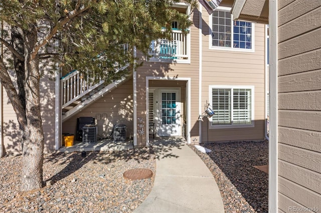 view of exterior entry featuring a patio area and central air condition unit