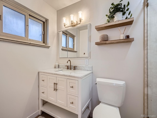 bathroom with vanity and toilet