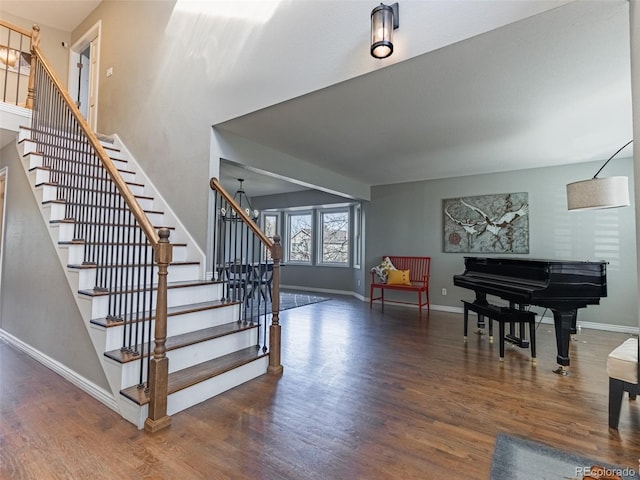 stairs featuring wood finished floors and baseboards