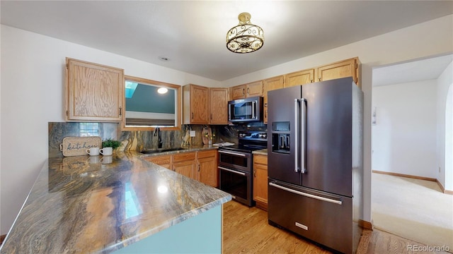 941 E 130th Cir, Thornton, CO 80241 - kitchen with appliances with stainless steel finishes, decorative backsplash, light wood-type flooring, and light brown cabinets