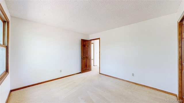 941 E 130th Cir, Thornton, CO 80241 - empty room featuring light carpet and a textured ceiling