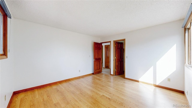 941 E 130th Cir, Thornton, CO 80241 - empty room featuring light wood-style flooring and a textured ceiling