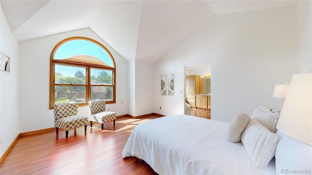 941 E 130th Cir, Thornton, CO 80241 - bedroom featuring vaulted ceiling and wood finished floors