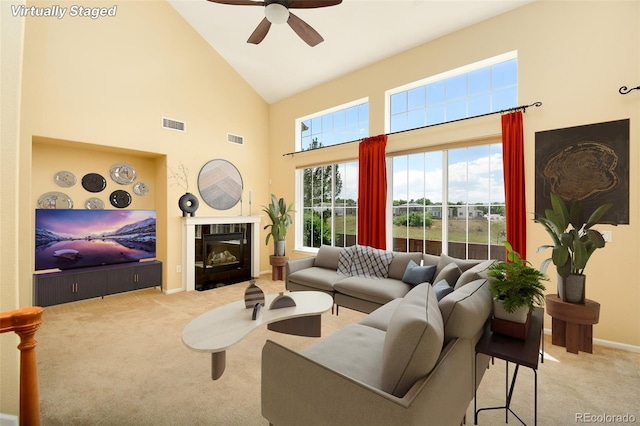 10597 Ashfield St, Highlands Ranch, CO 80126 - living area featuring carpet, high vaulted ceiling, ceiling fan, and a tile fireplace