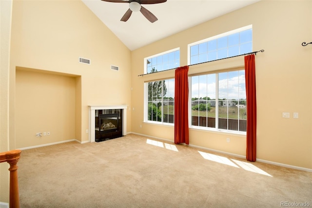 10597 Ashfield St, Highlands Ranch, CO 80126 - unfurnished living room with high vaulted ceiling, ceiling fan, carpet floors, and plenty of natural light
