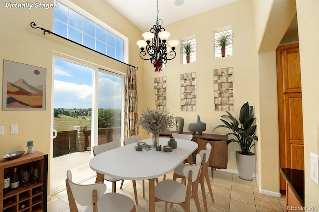 10597 Ashfield St, Highlands Ranch, CO 80126 - dining space featuring a high ceiling, a chandelier, and light tile patterned floors