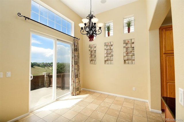 10597 Ashfield St, Highlands Ranch, CO 80126 - unfurnished dining area with healthy amount of natural light, a high ceiling, light tile patterned floors, and a chandelier