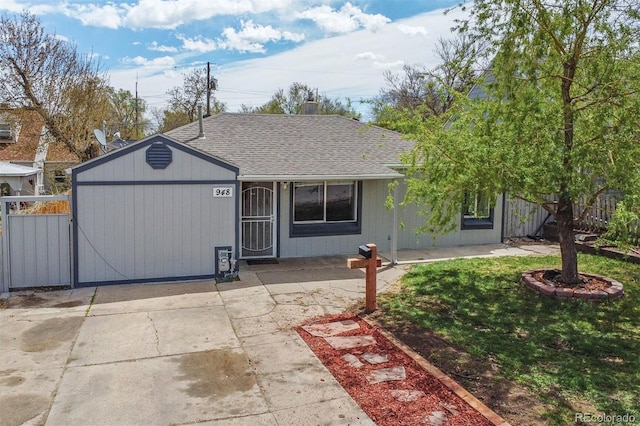 view of front of home with fence, a chimney, roof with shingles, and a front yard