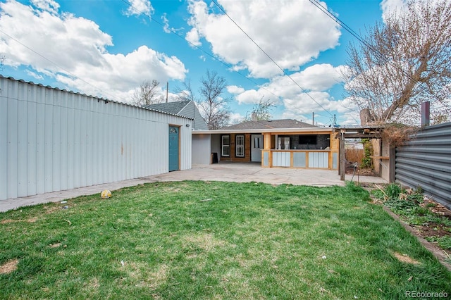 rear view of property with a lawn, fence, and a patio area