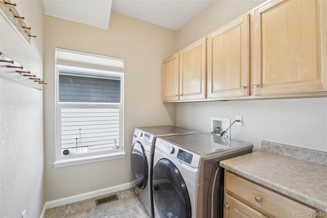 laundry room featuring cabinet space, separate washer and dryer, and baseboards