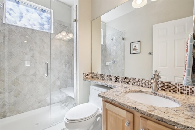 full bath with toilet, a stall shower, and vanity