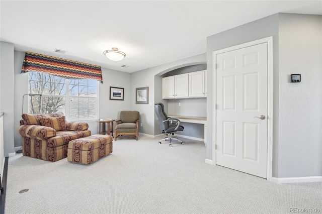 office area with light carpet and baseboards
