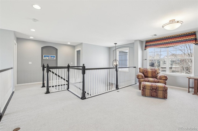 sitting room with an upstairs landing, carpet, recessed lighting, and baseboards