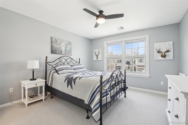bedroom with light carpet, baseboards, and a ceiling fan