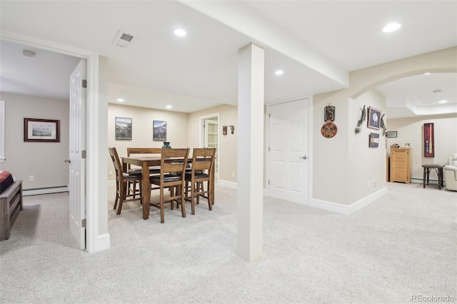 carpeted dining room with a baseboard radiator, recessed lighting, baseboards, and arched walkways