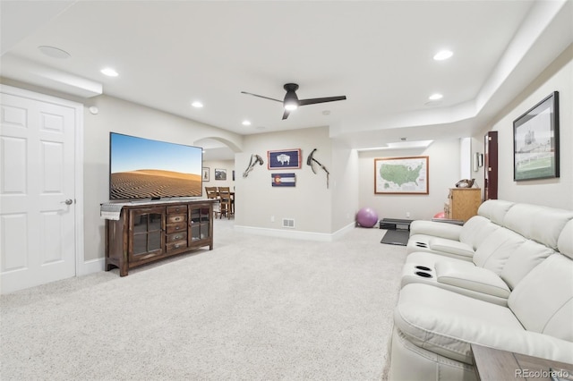 carpeted living area featuring arched walkways, recessed lighting, baseboards, and ceiling fan
