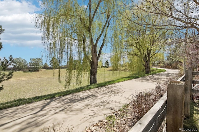 view of property's community featuring driveway and a yard