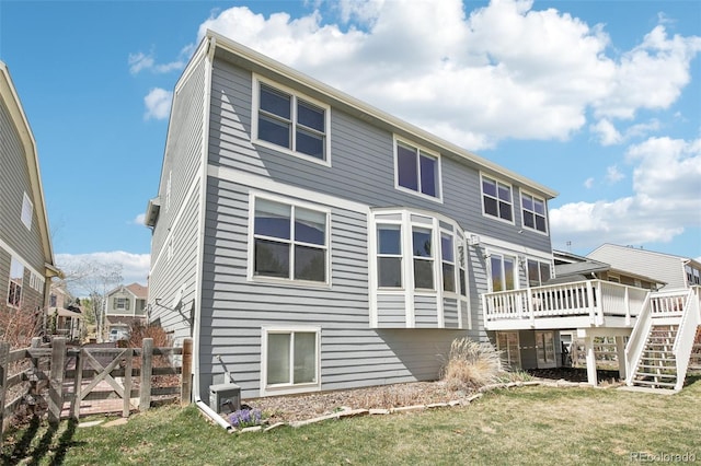 back of house featuring a wooden deck and stairway