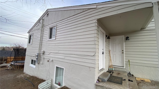 exterior space with fence and stucco siding