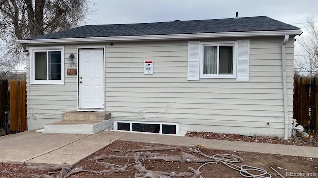 exterior space featuring entry steps and fence