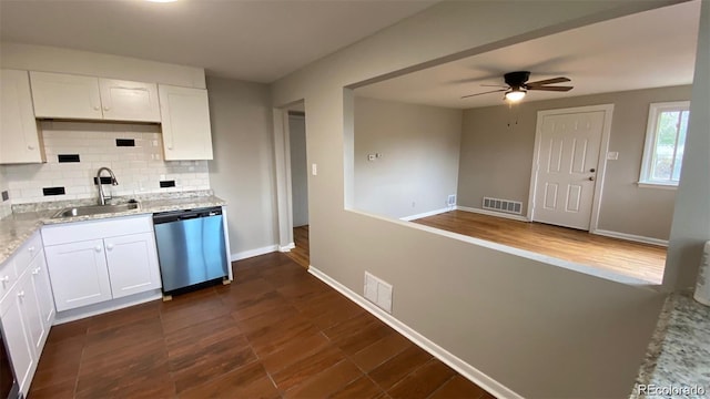 kitchen featuring stainless steel dishwasher, a sink, visible vents, and decorative backsplash