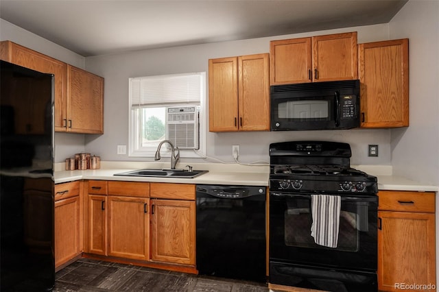 kitchen featuring black appliances, dark hardwood / wood-style flooring, and sink