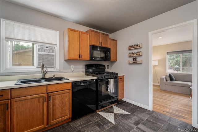 kitchen featuring sink, black appliances, and a healthy amount of sunlight