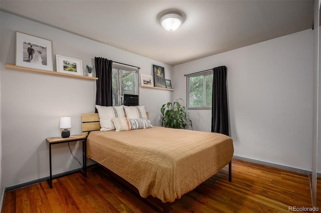 bedroom with dark wood-type flooring