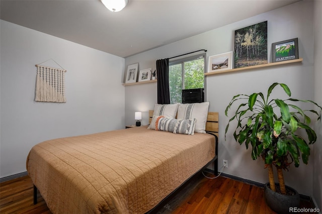 bedroom featuring dark hardwood / wood-style flooring