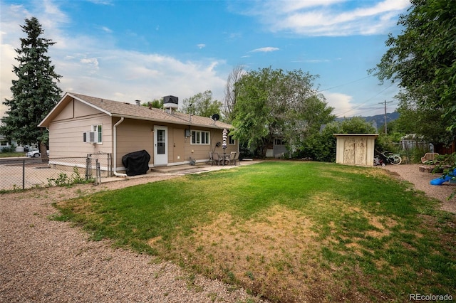 view of yard featuring a storage shed and a patio