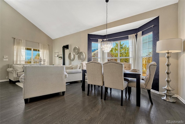 dining space with high vaulted ceiling, dark wood-type flooring, and a chandelier