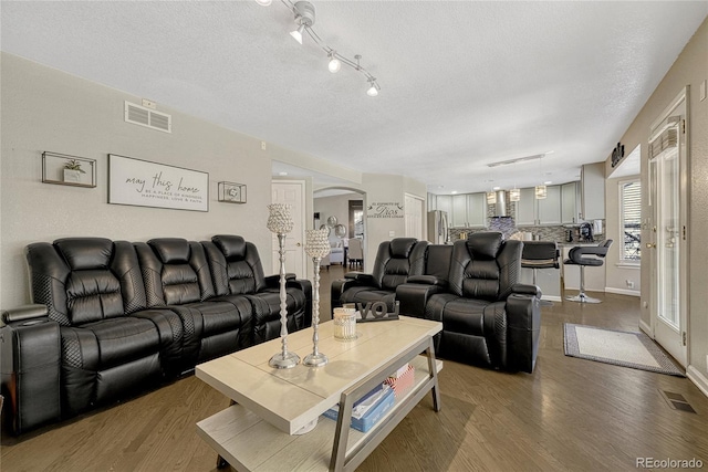 living room featuring hardwood / wood-style floors and a textured ceiling