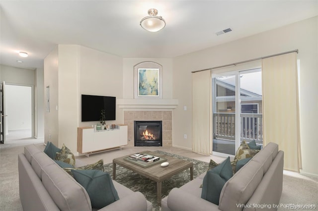 living room with light carpet and a tile fireplace