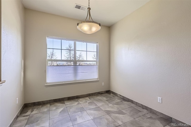 spare room featuring light tile patterned floors