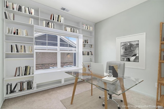 home office featuring carpet floors and built in shelves